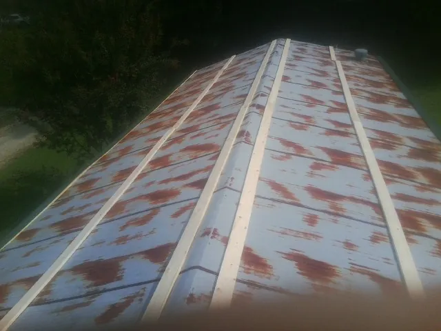 Rusted metal roof panels with new wood purlins before replacement — Storm Damage Roof Repair in Anderson by Roofing Brothers